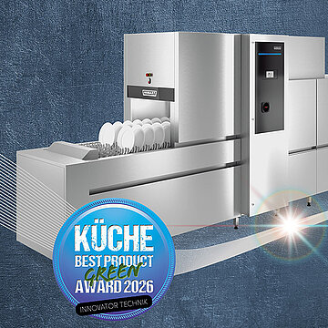 A stainless steel HOBART conveyor dishwasher displayed on a textured blue background, shown with dish racks filled with plates and accompanied by a circular blue badge labeled “KÜCHE Best Product Green Award 2026”.